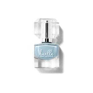 Huella Cold as Ice nail lacquer in a frosted blue shade with gray undertones, featuring a 15-free, vegan, and chip-resistant formula.