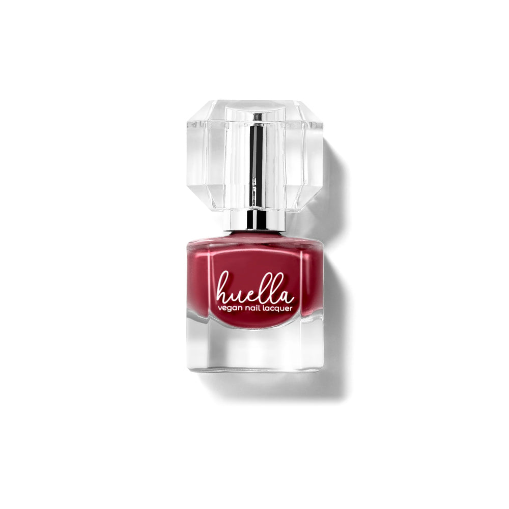 Huella Heartbreaker nail lacquer in a rich burgundy shade with plum undertones, featuring a 15-free, vegan, and chip-resistant formula.