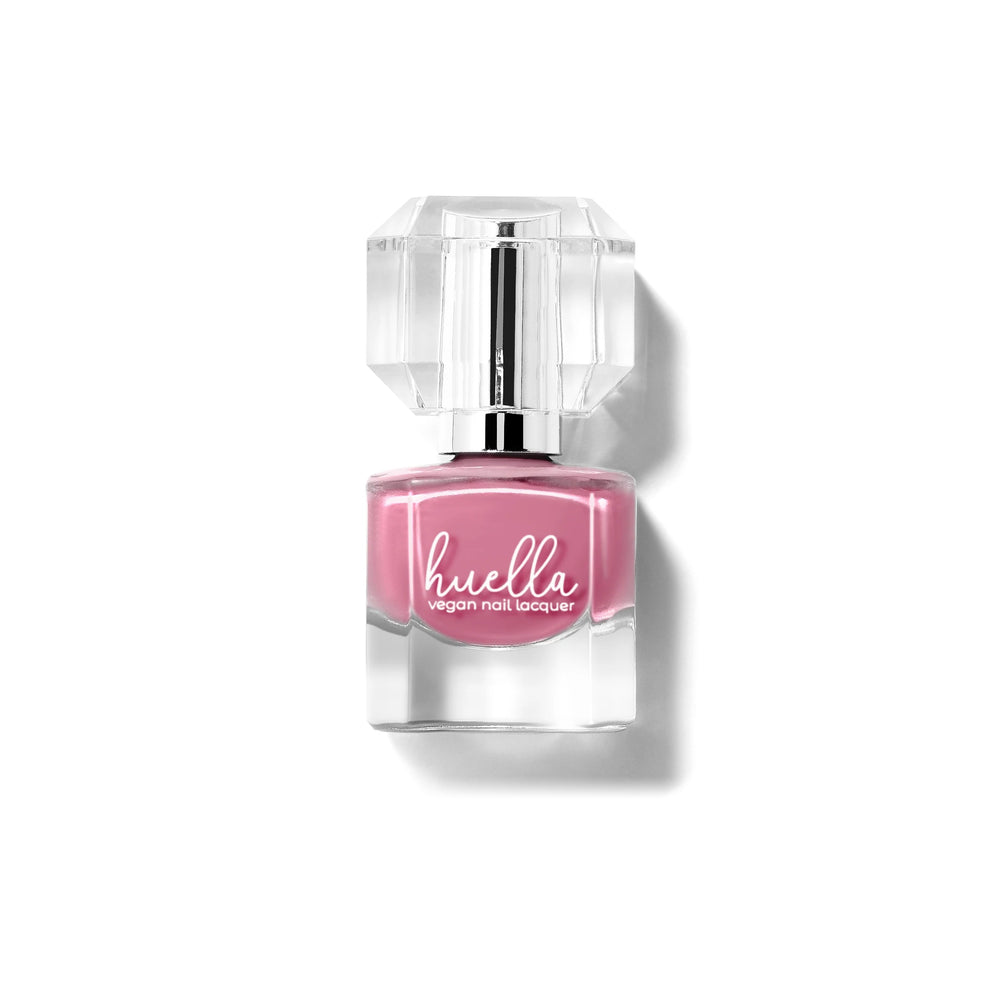 Huella Kiss and Tell nail lacquer in a soft mauve pink shade, featuring a 15-free, vegan, and chip-resistant formula.