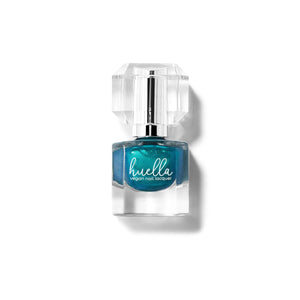 Huella Love, Genevieve nail lacquer in a shimmery teal shade, featuring a 15-free, vegan, and chip-resistant formula.