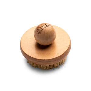 Wooden brush with bristles on a white background. INBLUEM Lotus Wood Body Brush