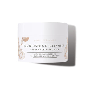 A white cosmetic jar of Jane Scrivner Nourishing Cleanser Luxury Cleansing Balm with gold botanical illustrations and black text, set against a clean white background with a soft shadow.