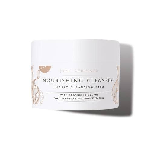 A white cosmetic jar of Jane Scrivner Nourishing Cleanser Luxury Cleansing Balm with gold botanical illustrations and black text, set against a clean white background with a soft shadow.