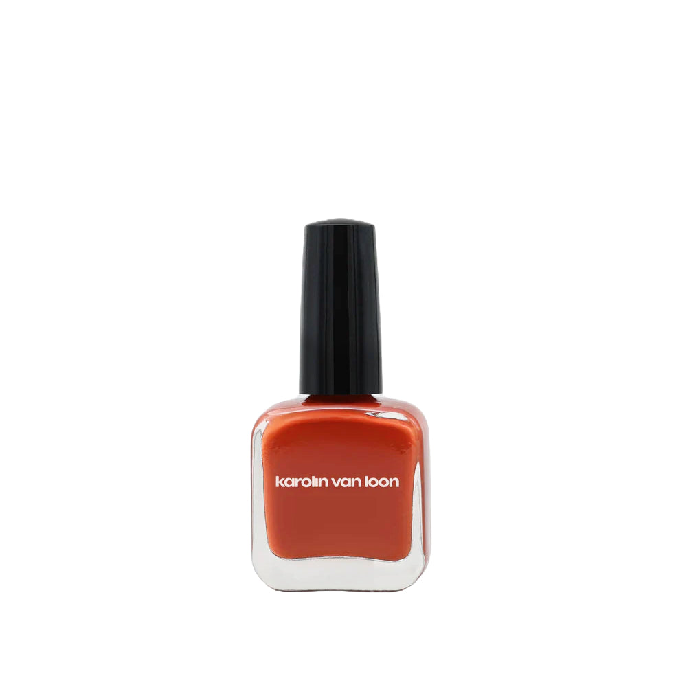 A bottle of Karolin Van Loon nail polish in shade 49 Sienne Cuir, featuring a warm terracotta color that evokes dreams of Moroccan deserts and Tuscan terraces, suitable for both summer and autumn palettes.