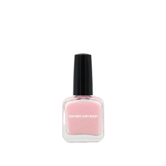 A bottle of Karolin Van Loon nail polish in shade 50 Rosé Doux, featuring a soft mademoiselle pink color perfect for all seasons, offering a delicate ballerina look in winter and a playful cotton candy hue for summer.