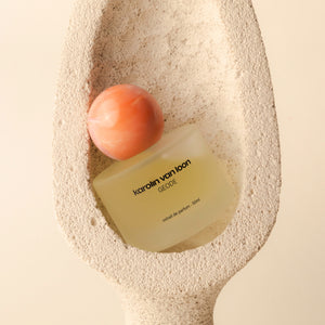 Karolin van Loon Geode perfume bottle on a textured beige surface