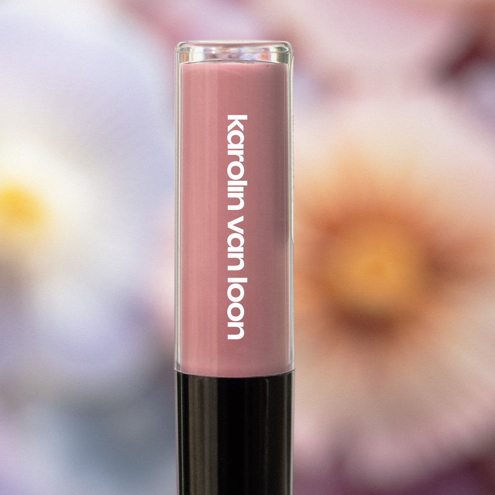A tube of Karolin Van Loon lip gloss in Violet, featuring a luscious shade with dusky undertones that captures the essence of twilight. This hydrating gloss provides a subtle tint and radiant shine, leaving lips looking fuller and more voluminous.