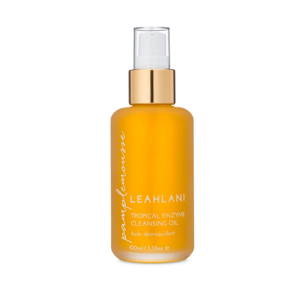 Leahlani Skincare Pamplemousse Cleansing Oil – brightening daily enzyme cleanser in a glass pump bottle, infused with grapefruit, pineapple, papaya, vanilla, and plumeria.