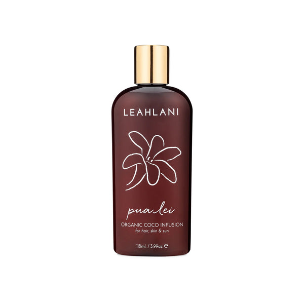 Leahlani Skincare Pua Lei Coco Infusion body oil in a bottle, a lightweight coconut and kukui oil blend with tropical florals for silky, nourished skin and lustrous hair.