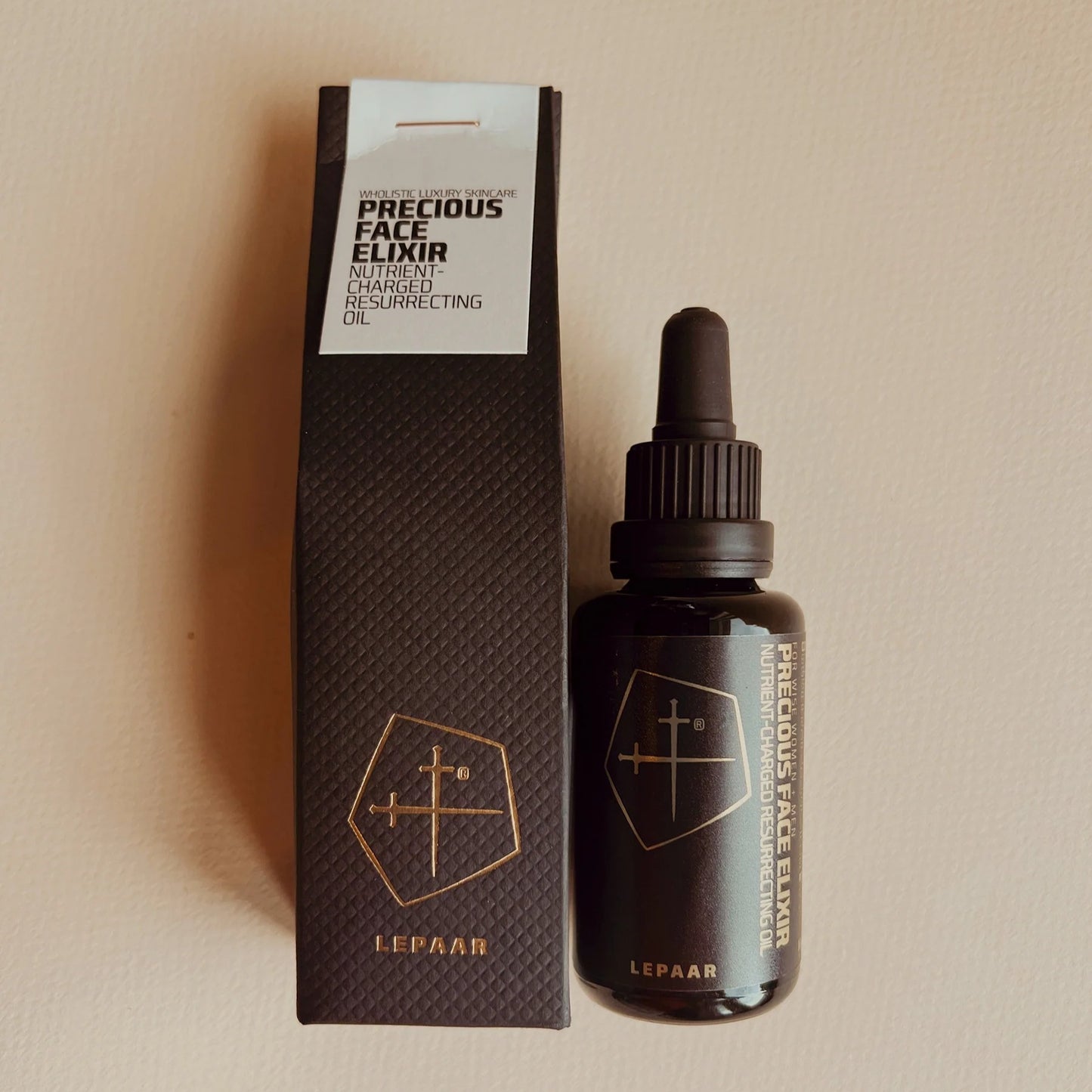 Lepaar Precious Face Elixir bottle and packaging on a beige background