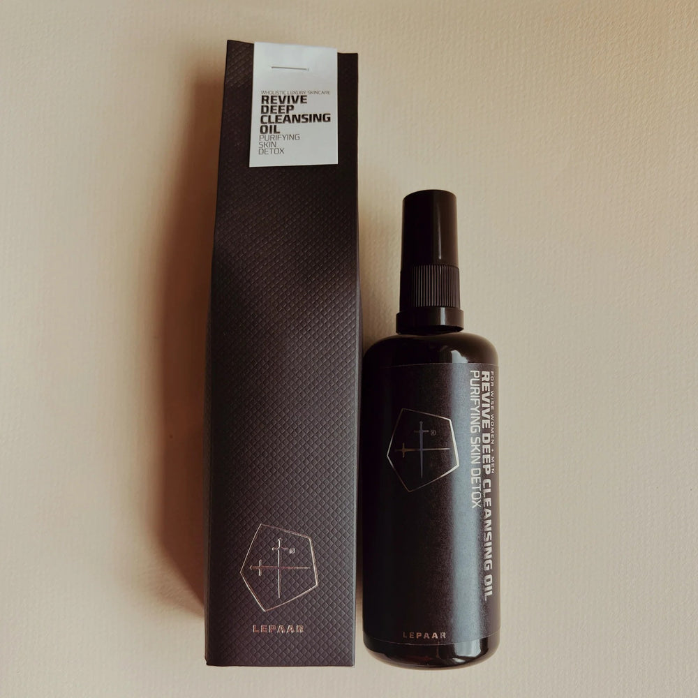 Bottle of Lepaar Revive Deep Cleansing Oil in matte black Miron glass with pump dispenser, set against a clean white background—highlighting the sleek minimalist design, subtle logo, and rich amber liquid inside. 