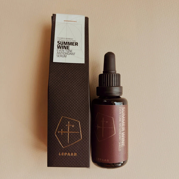 Bottle and packaging of 'Summer Wine' serum by Lepaar on a beige background. LEPAAR Summer Wine / Even Tone Antioxidant Shield / Zero Essential Oils ALWAYS SHOW