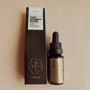 Yuzu Vitamin C Serum bottle and packaging on a beige background. LEPAAR Yuzu Vitamin C Serum Complexion Saving Antioxidant Concentrate
