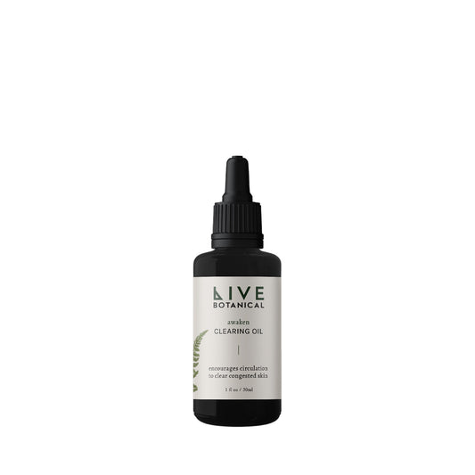 Live Botanical Awaken Clearing Oil in a bottle with a natural, earthy design. A blend of calendula, pumpkin seed, and black caraway seed oils to hydrate and soothe sensitive skin.