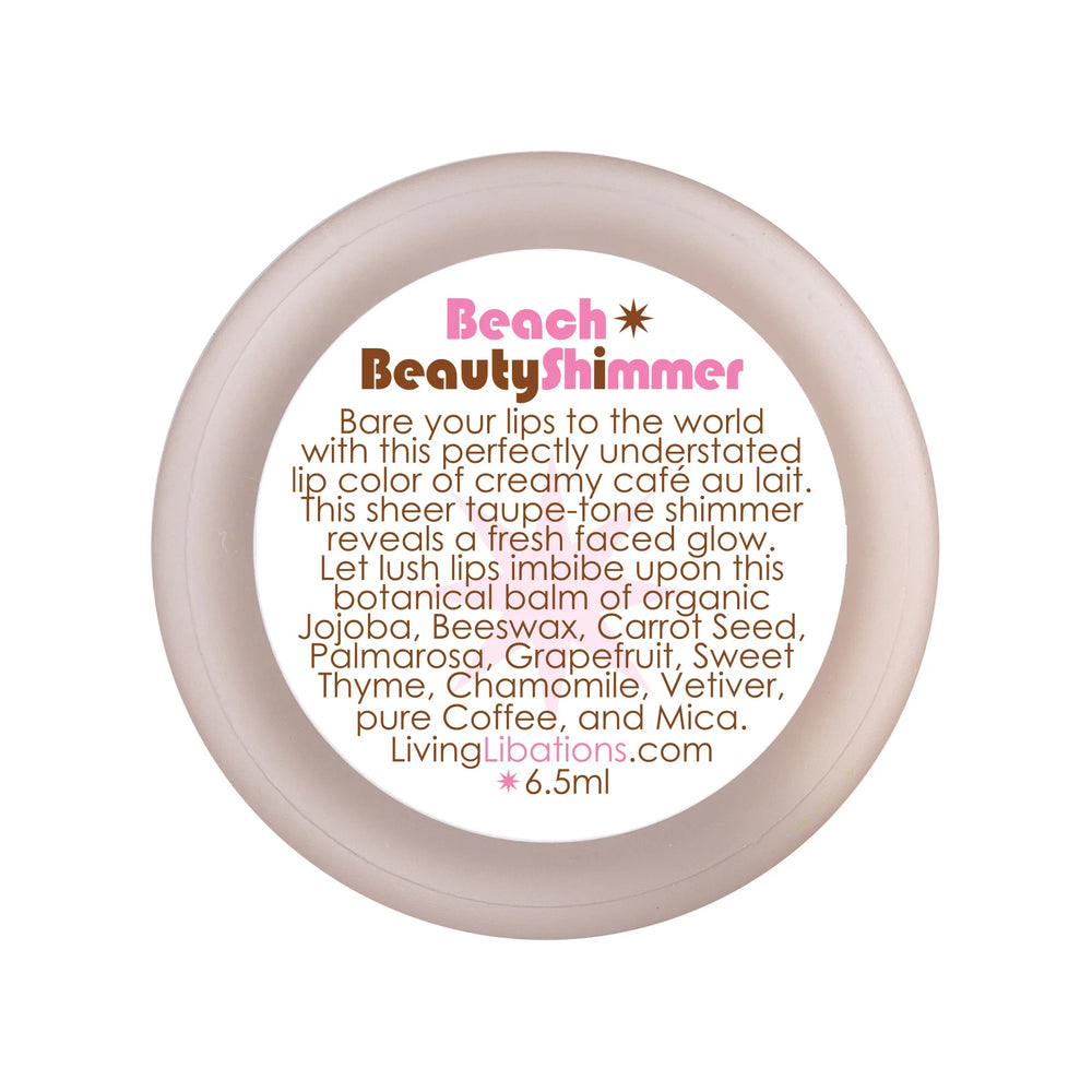 Living Libations Beach Beauty Shimmer lip balm with a soft, shimmering café au lait tint
