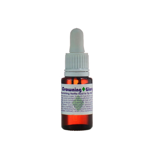 Living Libations Crowning Glory Hair Oil bottle, featuring nourishing ingredients like rosemary, nettles, and jojoba for hydrated, shiny, and strong hair. 15ml