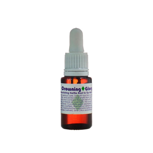 Living Libations Crowning Glory Hair Oil bottle, featuring nourishing ingredients like rosemary, nettles, and jojoba for hydrated, shiny, and strong hair. 15ml