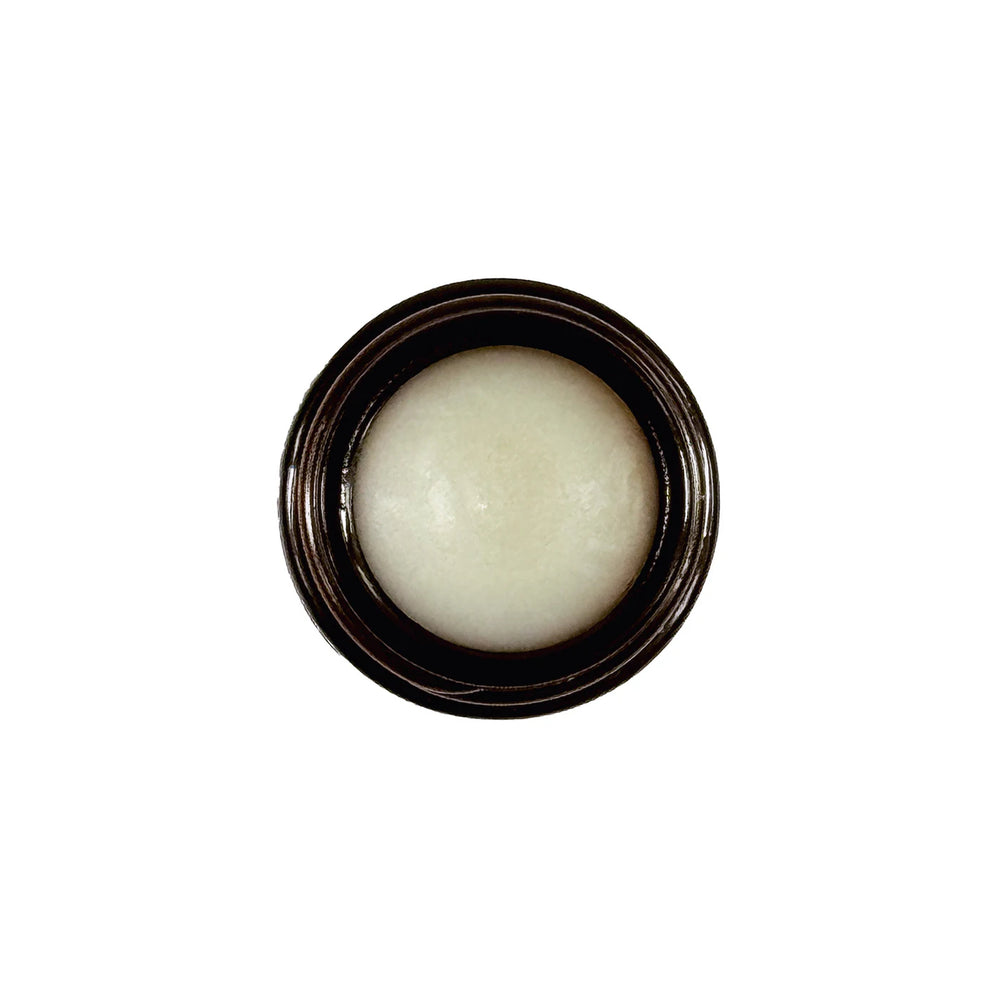 Living Libations Frankincense First Aid Ozonated Gel Balm in a small glass jar with a white lid.