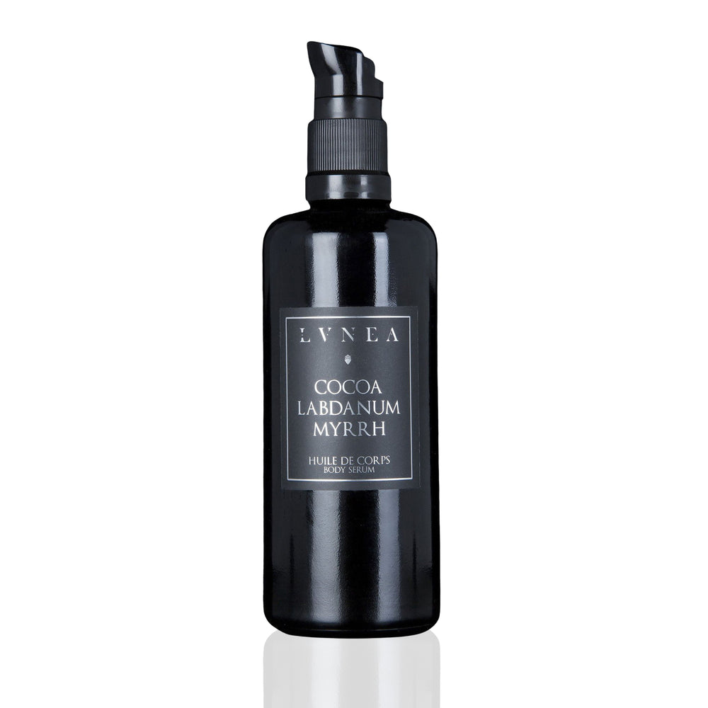 LVNEA Cocoa Labdanum Myrrh Body Serum in an amethyst glass bottle, showcasing a rich, warm blend of dark cocoa, labdanum, and myrrh. Ideal for moisturizing and soothing dry skin.