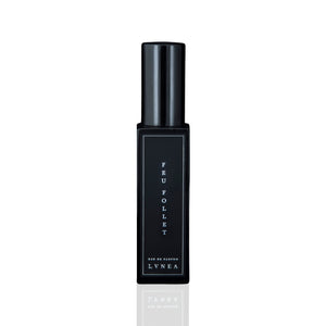 LVNEA Feu Follet Eau De Parfum - a black glass bottle containing a smoky, resinous fragrance with notes of pine tar, burnt wood, leather, and tree resin. Presented with an atomizer spray top. 30ml
