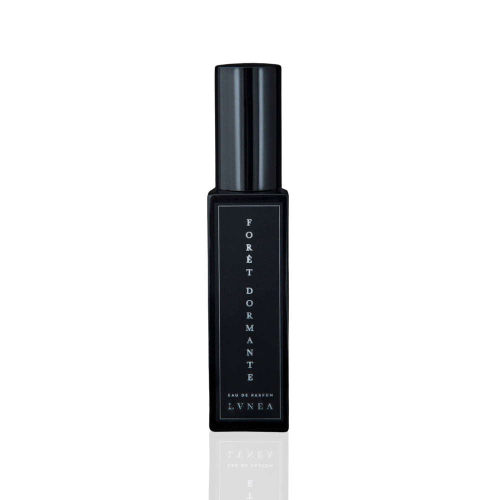 LVNEA Forêt Dormante Eau De Parfum in a 30ml black glass bottle with notes of piñon pine, lavender, rose de mai, and frankincense, evoking the calm, dewy slumber of a pre-dawn forest. 30ml