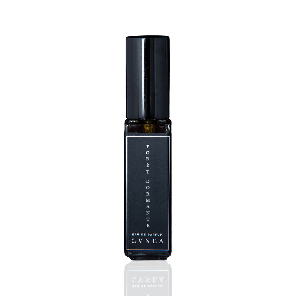 LVNEA Forêt Dormante Eau De Parfum in a 30ml black glass bottle with notes of piñon pine, lavender, rose de mai, and frankincense, evoking the calm, dewy slumber of a pre-dawn forest. 30ml