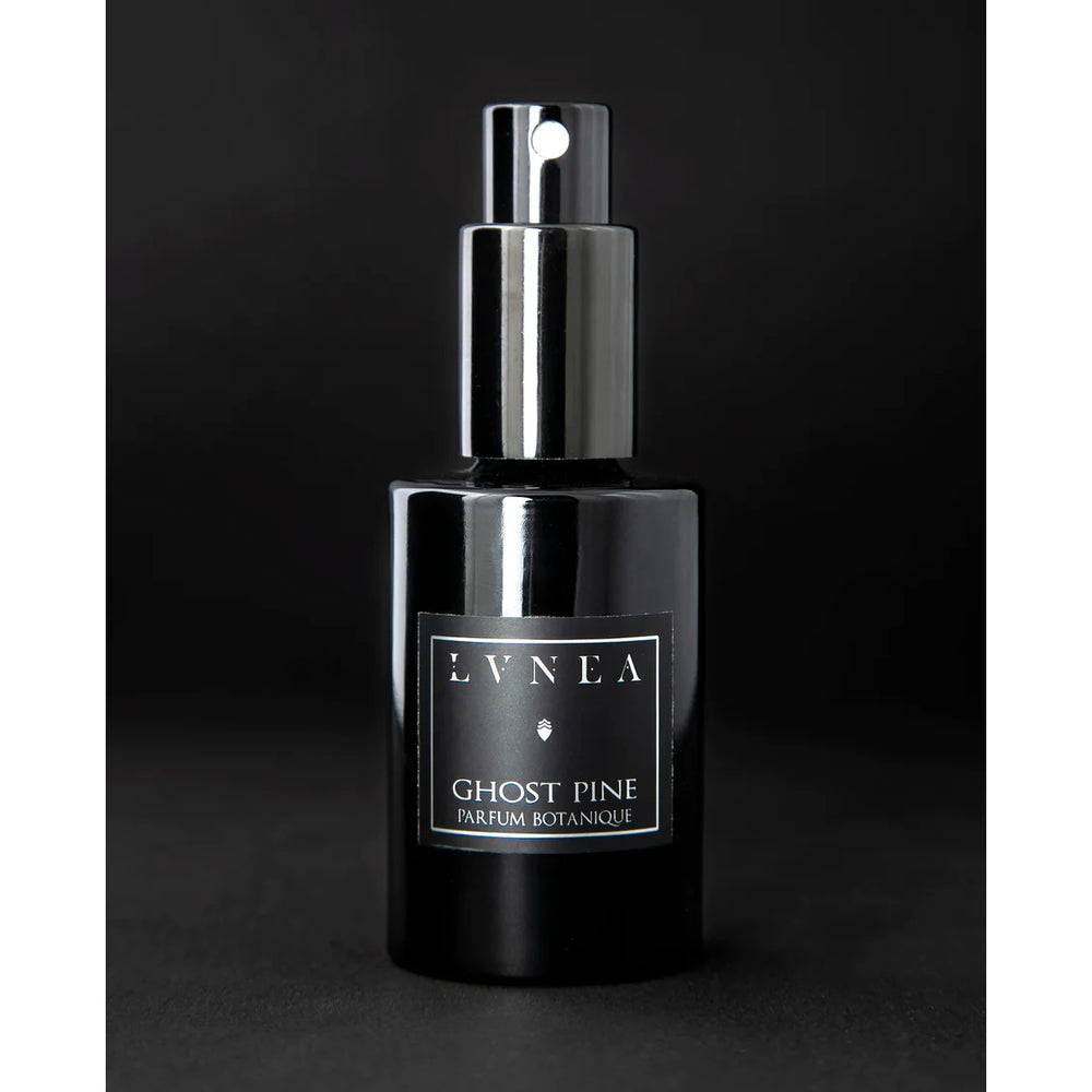 LVNEA Ghost Pine Eau De Parfum – a 30ml amethyst glass bottle with a spray top, featuring a crisp coniferous fragrance with notes of pine needles, damp moss, and ancient woods, encased in a black travel-friendly tube.