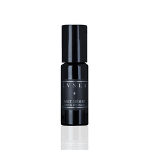 LVNEA Nuit Désert perfume in a 10ml amethyst glass bottle with a roller ball applicator, featuring a blend of cedar leaf, smoke, vetiver, and other earthy notes, encased in a matte black tube.