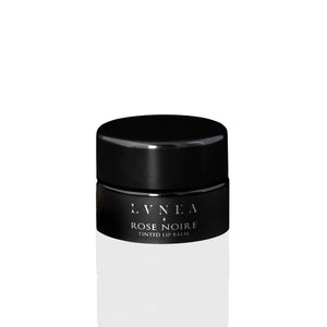 Luxurious Tinted Lip Balm: A rich, nourishing lip balm with a dark dusty rose tint, featuring botanical oils, butters, and natural rose wax. Offers a light floral fragrance and sweet taste, perfect for enhancing lips or as a dewy cheek stain.