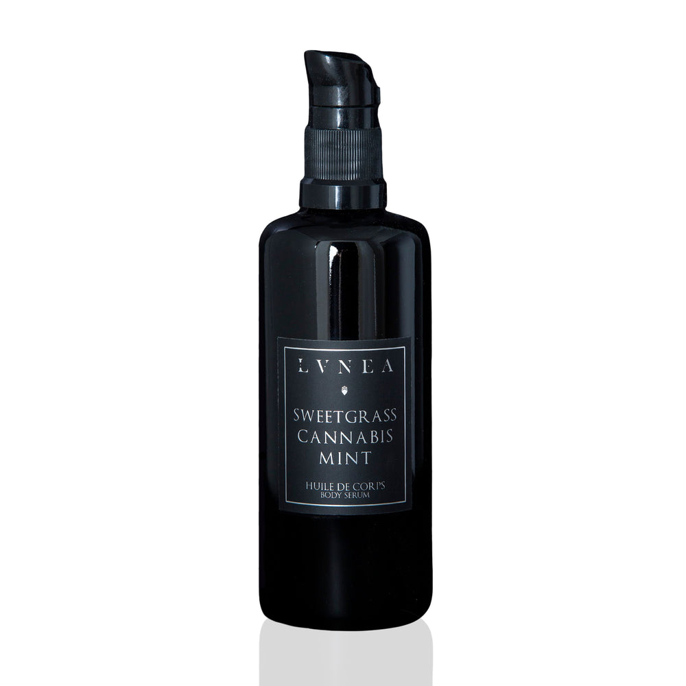 LVNEA Sweetgrass & Mint Botanical Body Serum in an amethyst glass bottle with a pump dispenser, featuring a fresh, cooling formula for moisturizing and soothing dry or hot skin.