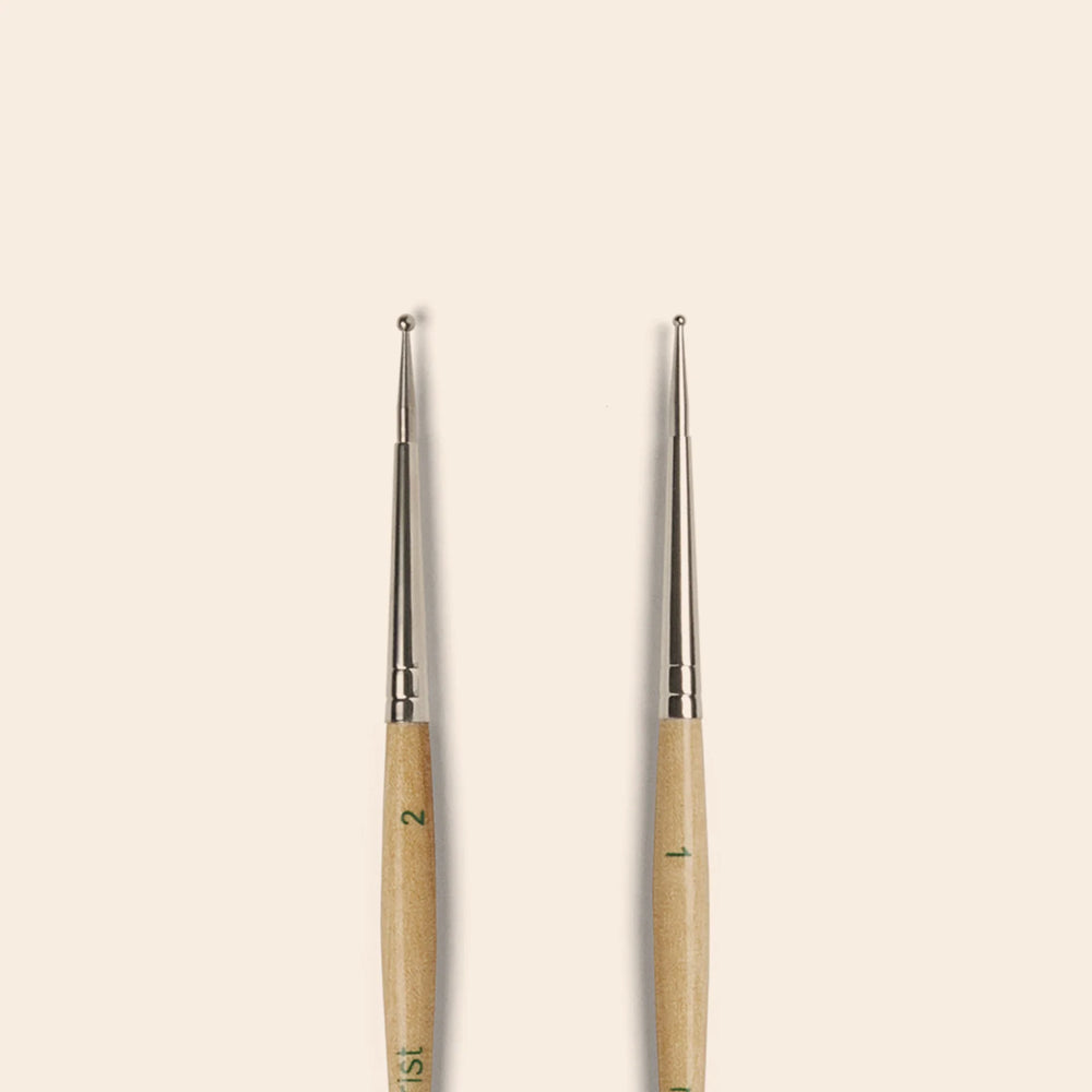 Manucurist Dotting Tool with dual precision tips and curved handle for easy nail art designs.