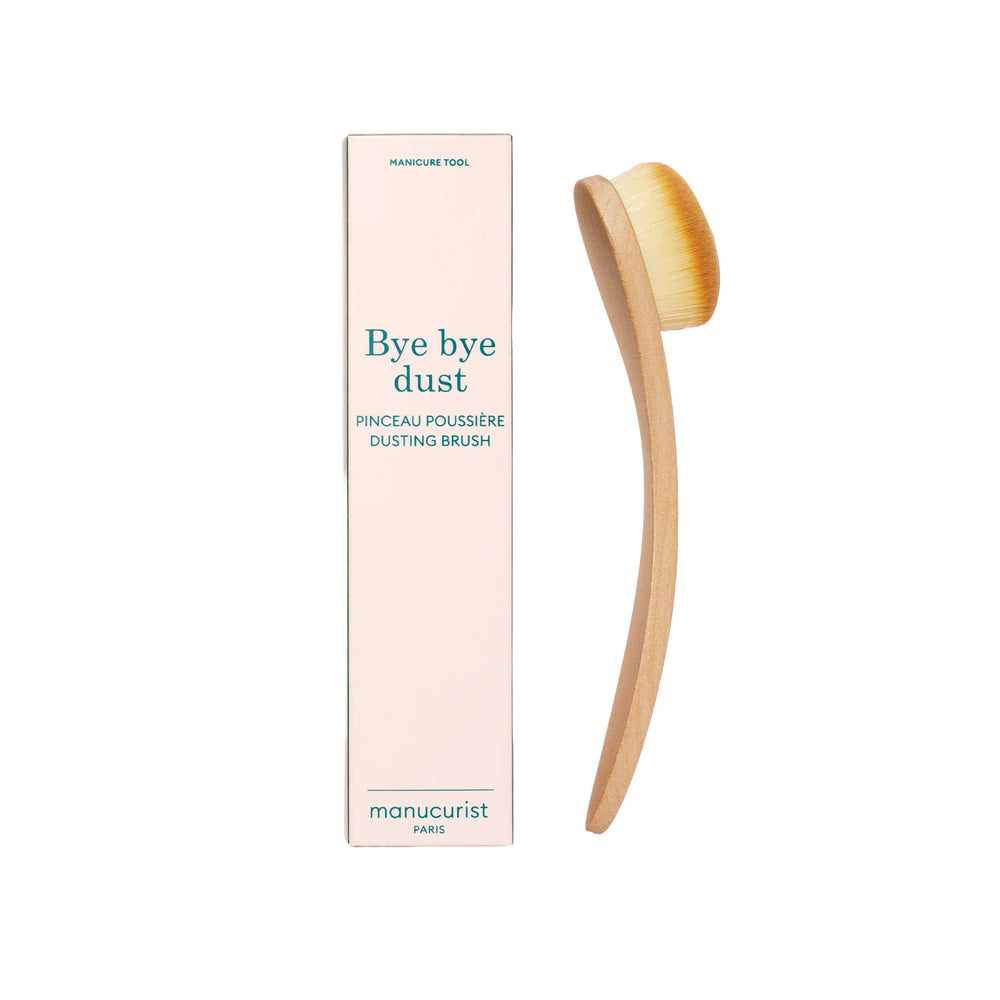 Manucurist Dust Brush with an ergonomic FSC wood handle and soft vegan bristles for cleaning residue and glitter.