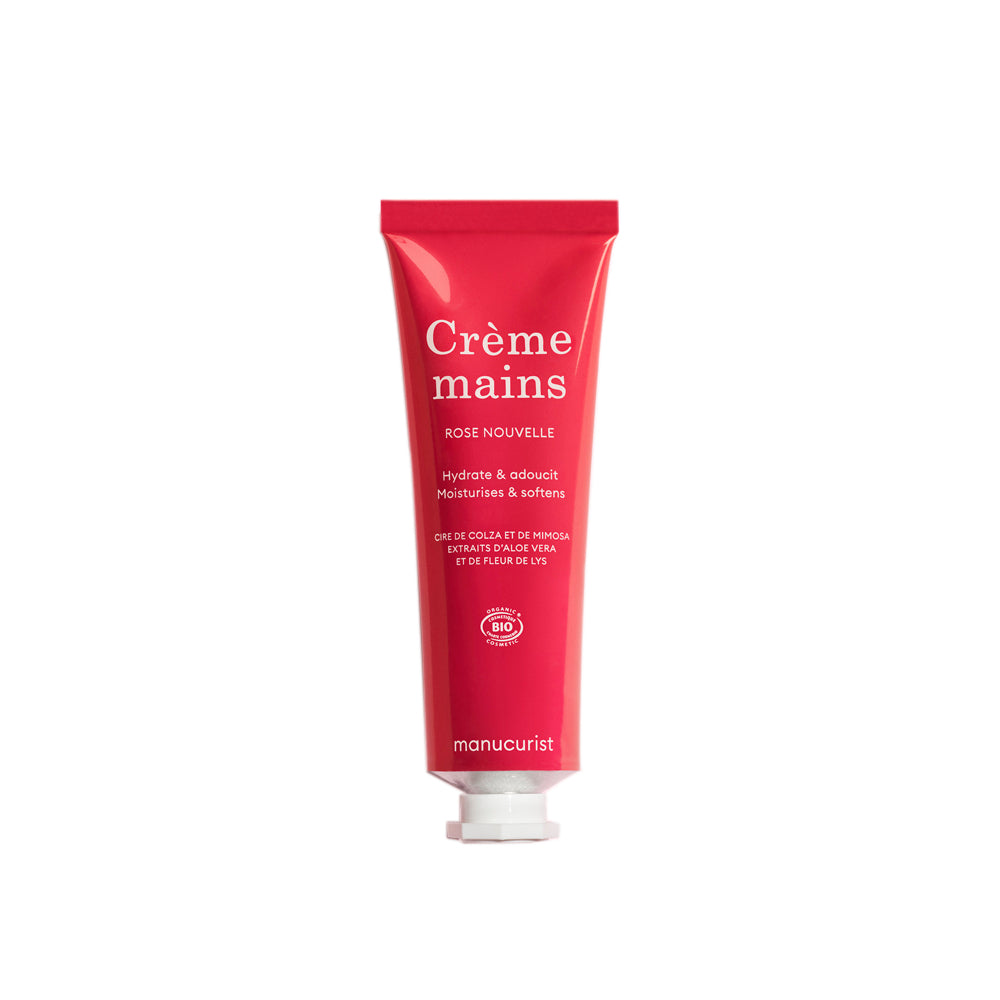 A red squeeze tube of manucurist Crème mains hand cream in the Rose Nouvelle scent, shown against a plain white background. 60ml