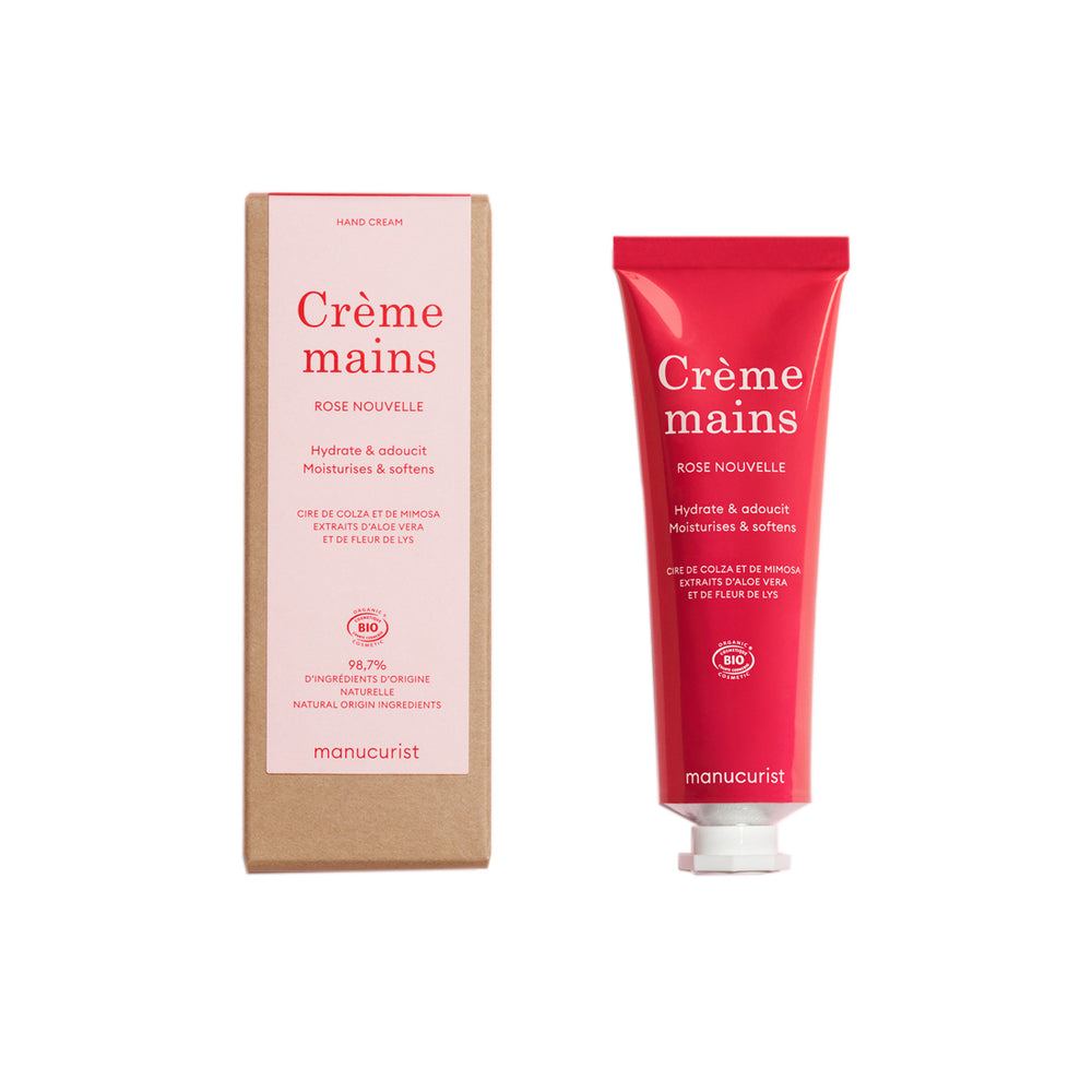 A red squeeze tube of manucurist Crème mains hand cream in the Rose Nouvelle scent, shown against a plain white background. 60ml