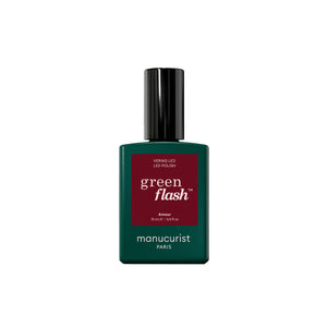A bottle of Manucurist Green Flash LED gel polish with a dark green bottle, a black cap, and a dark red label on a plain white background.