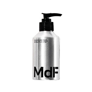 Silver bottle with black pump and 'MDF' branding on a white background