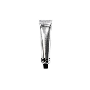 Silver tube with 'MDF' branding on a white background