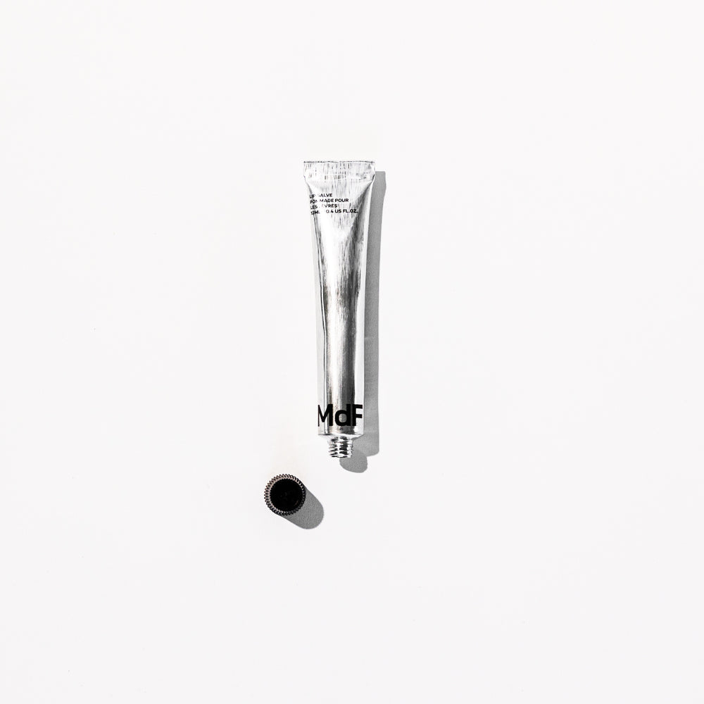 Silver tube with black text on a white background