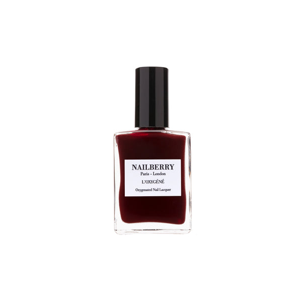 Bottle of Nailberry Kirsch Kiss dark cherry burgundy nail polish on white background.