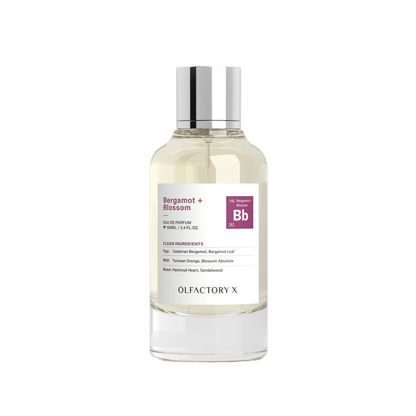 A clear glass bottle of Olfactory X Bergamot + Blossom Eau de Parfum with a silver cap and a white label featuring a purple 'Bb' logo, set against a plain white background.