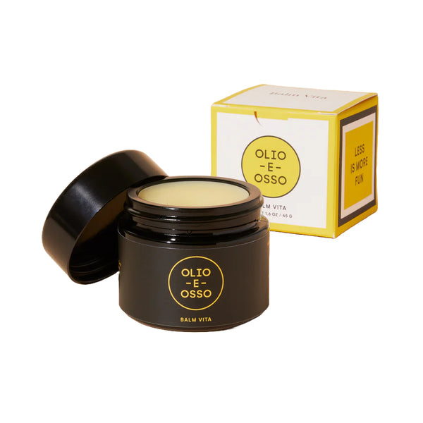 Black jar of Olio E Osso balm with open lid and packaging on a white background