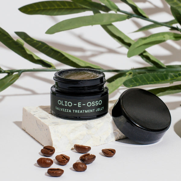 Olio E Osso Salvezza Jelly with coffee beans and green leaves on a light background