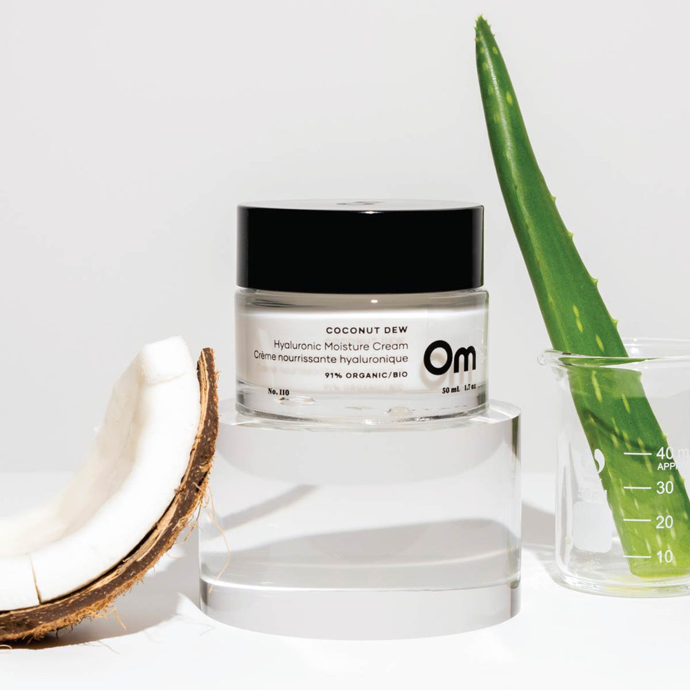 Om Organics Coconut Dew Hyaluronic Moisture Cream in a glass jar, a lightweight moisturizer for soft, hydrated skin.