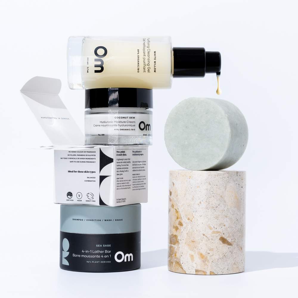 OM Organics Glow and Go set with facial cleanser, multi-use lather bar, and hydrating moisturizer arranged together for everyday skin and hair care.