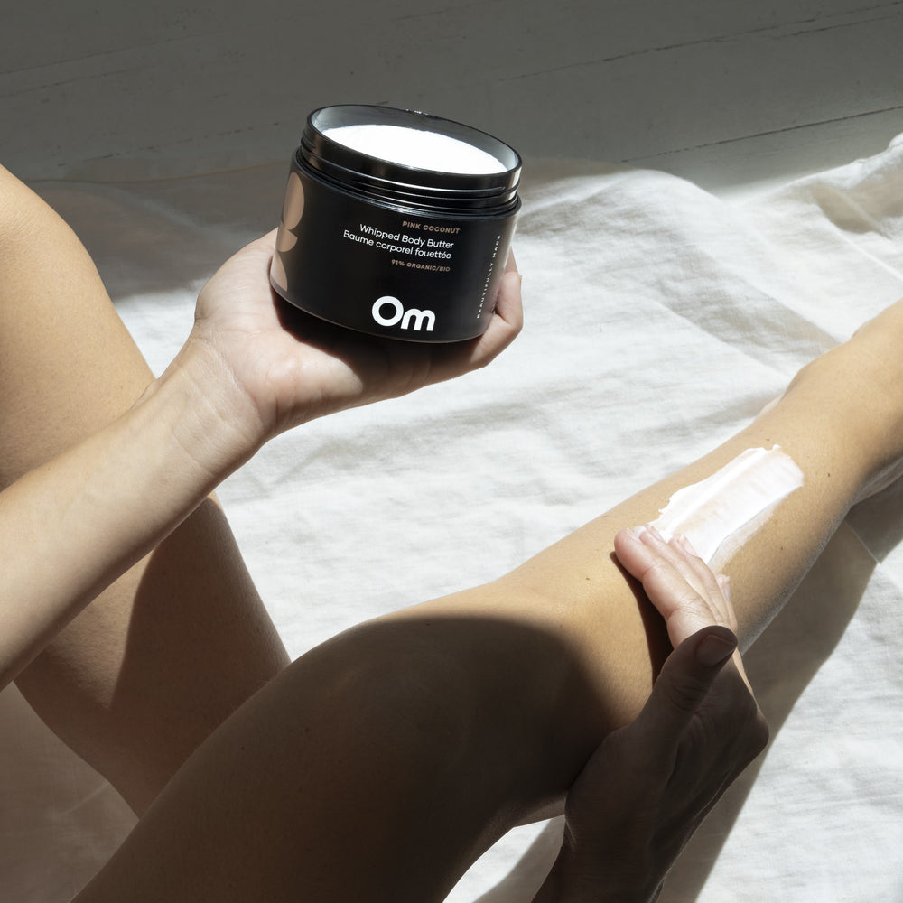Om Organics Neroli + Pepper Whipped Body Butter in a glass jar, a rich and nourishing cream for soft, hydrated skin.