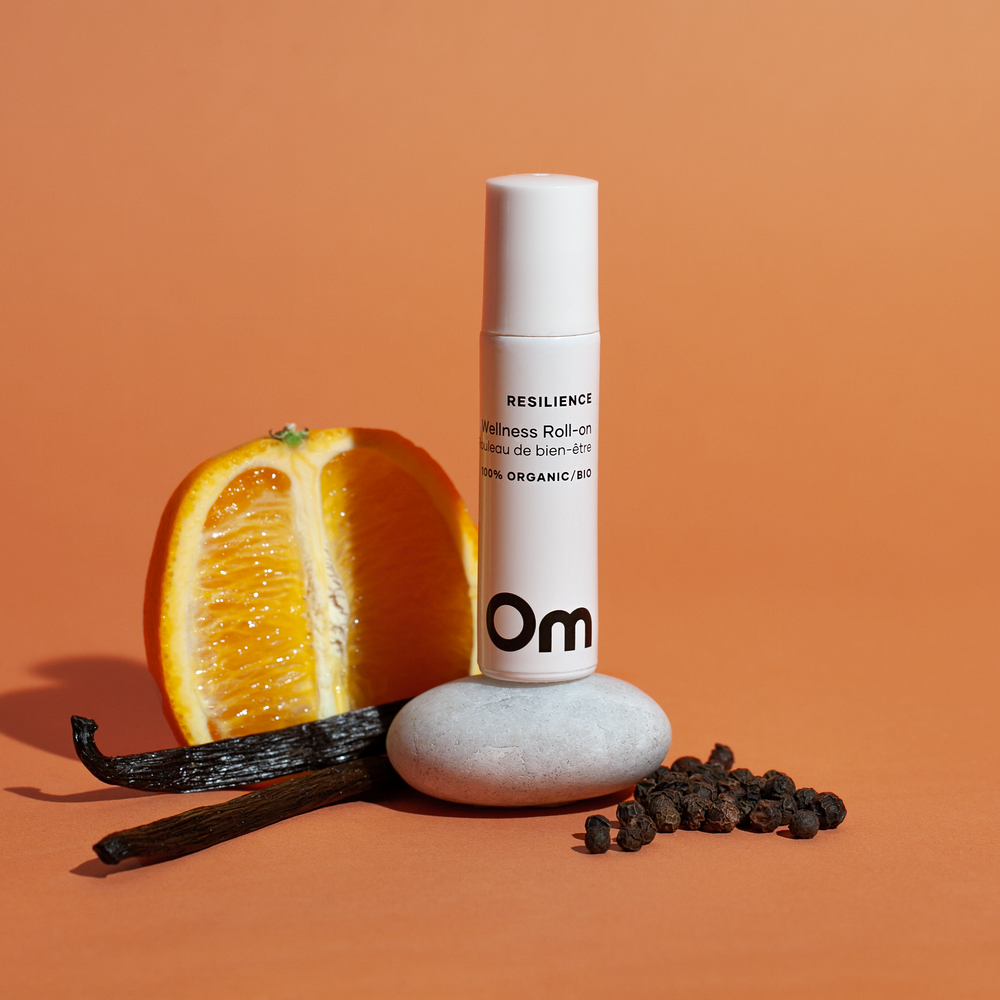 Om Organics Resilience Wellness Roll-On, a refreshing blend of sweet orange, black pepper, and vanilla in a 10 ml bottle. Organic, vegan, and cruelty-free.