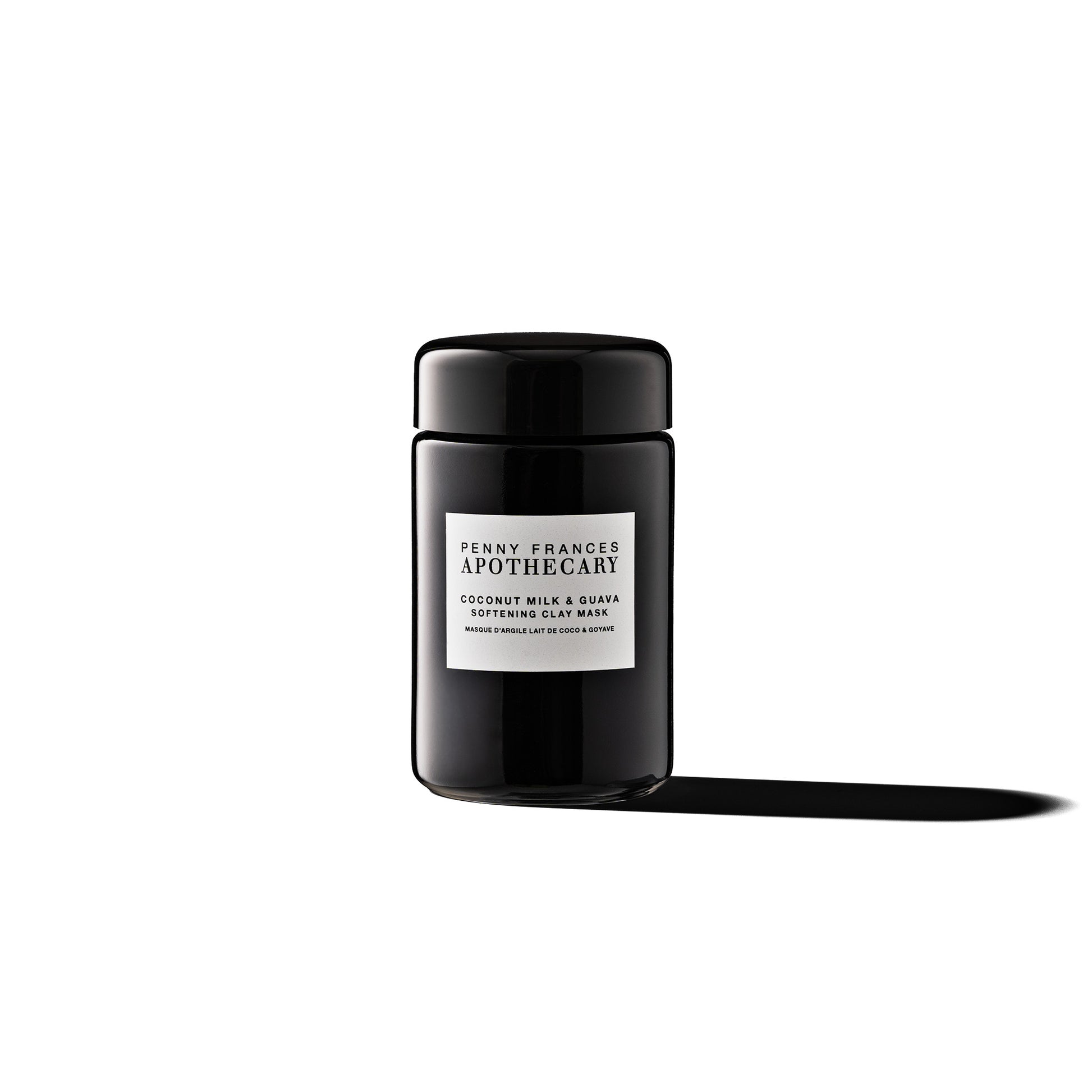 Glass jar of Penny Frances Apothecary Coconut Milk & Guava Softening Clay Mask with tropical fruit extracts, coconut milk, and rhassoul clay.