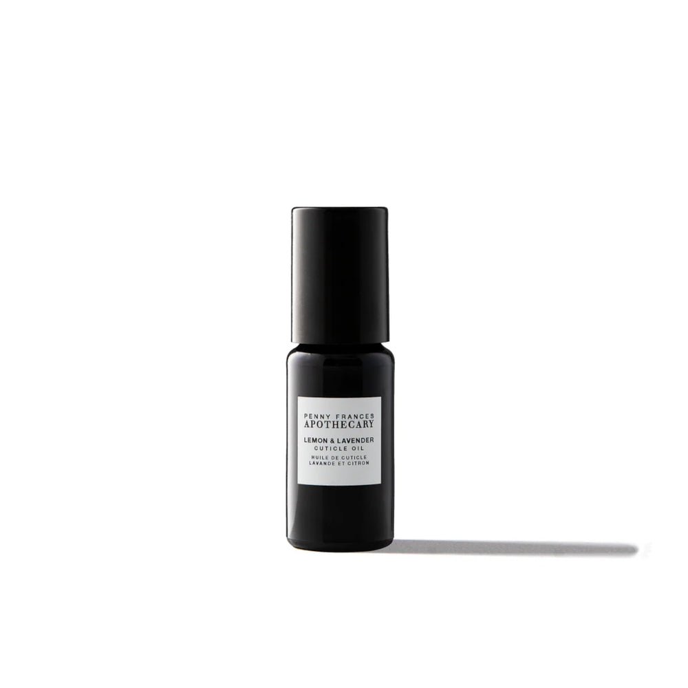 Bottle of Penny Frances Apothecary Lemon & Lavender Nail & Cuticle Oil with lavender sprigs, lemon, and natural botanical oils for nail care.