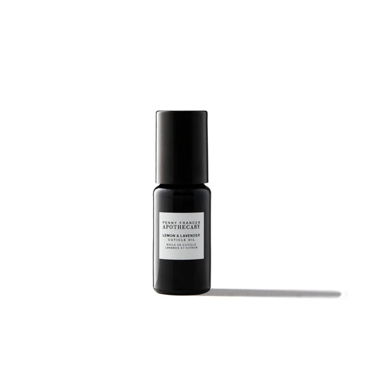 Bottle of Penny Frances Apothecary Lemon & Lavender Nail & Cuticle Oil with lavender sprigs, lemon, and natural botanical oils for nail care.
