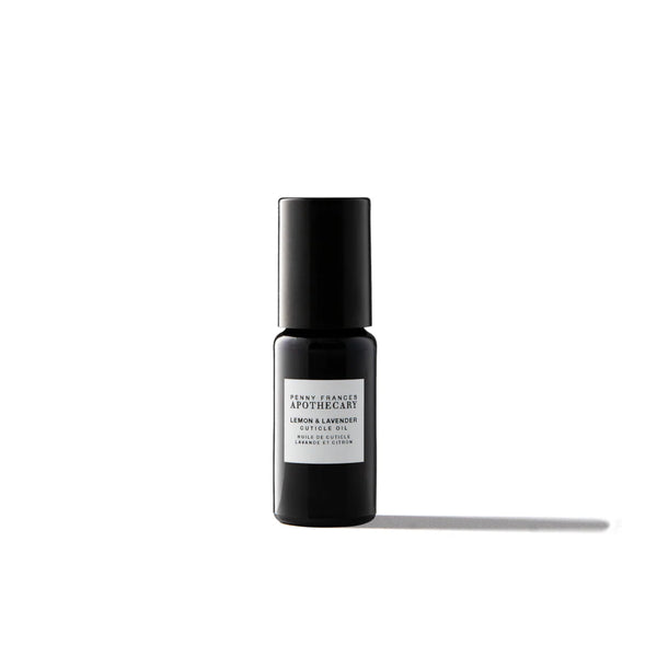 Bottle of Penny Frances Apothecary Lemon & Lavender Nail & Cuticle Oil with lavender sprigs, lemon, and natural botanical oils for nail care.